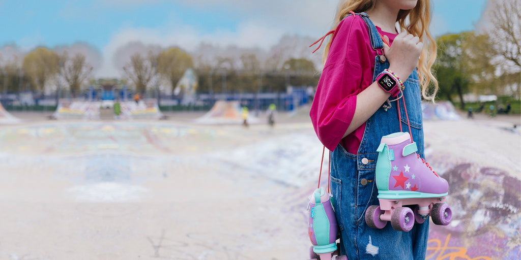 Teen girl confidently wearing a Tikkers smartwatch at a skate park